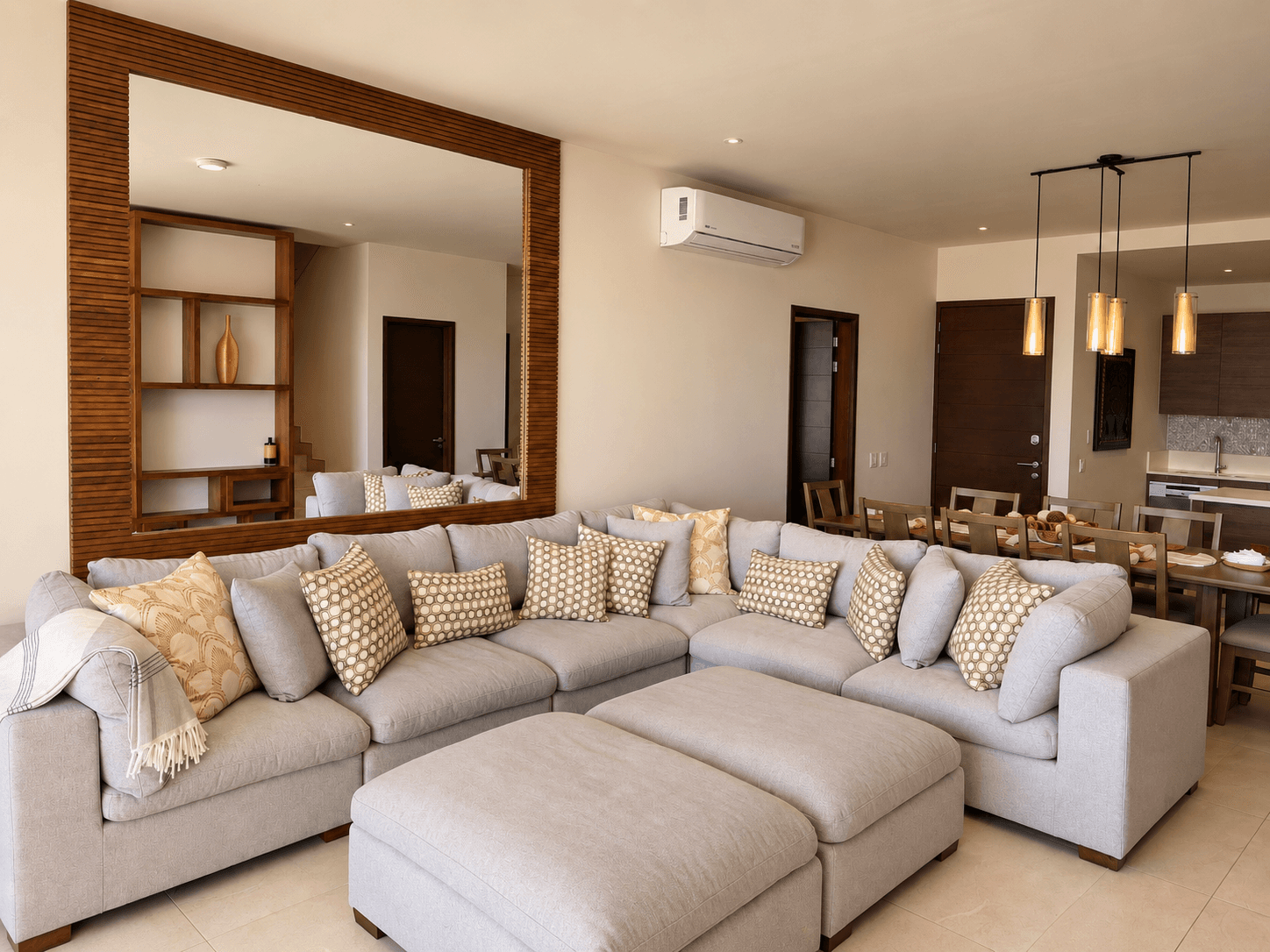 Spacious living room with sectional sofa and decorative mirror.