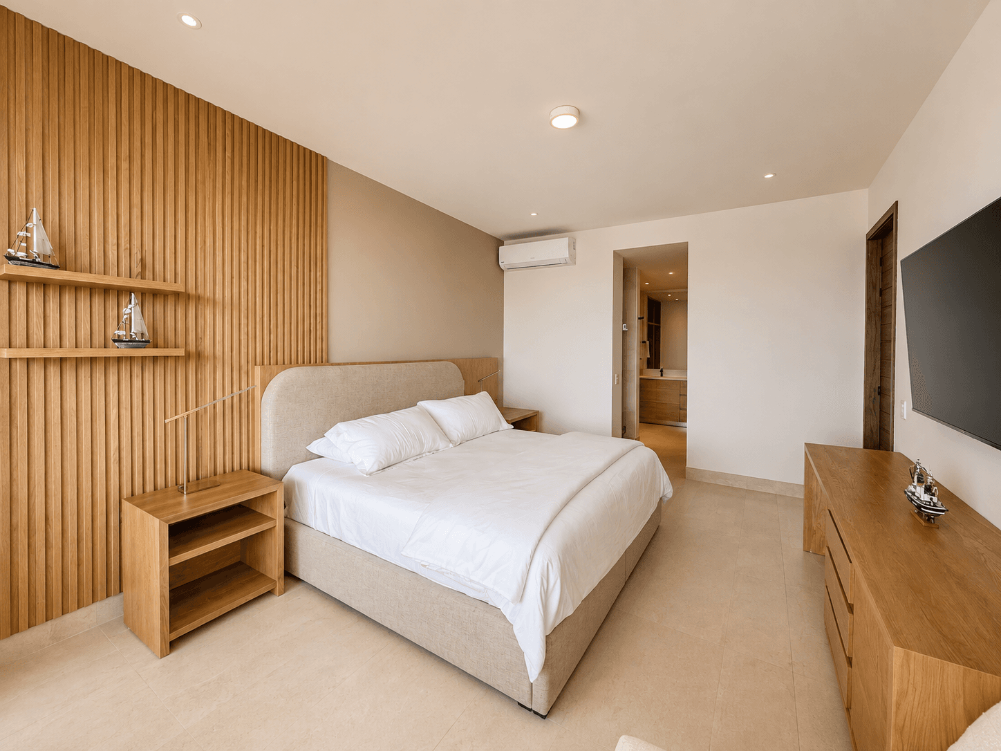 Master bedroom with wood finishes and en-suite bathroom.